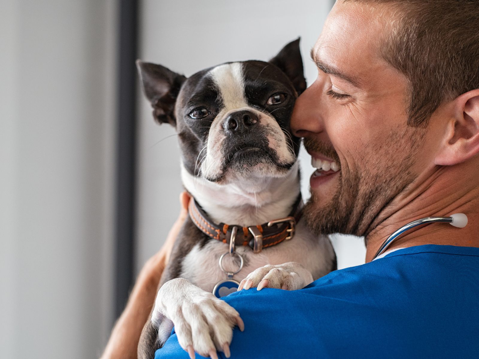 A man cradles a dog in his arms